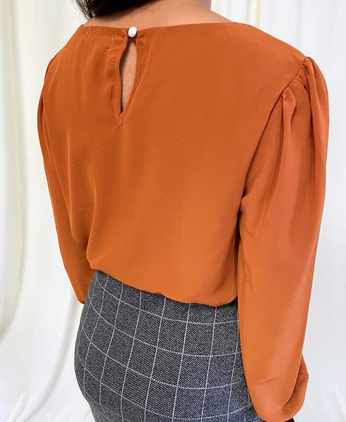 Long Sleeve Chiffon Blouse with Crew Neckline and Pearl Cuffs in Burnt Orange